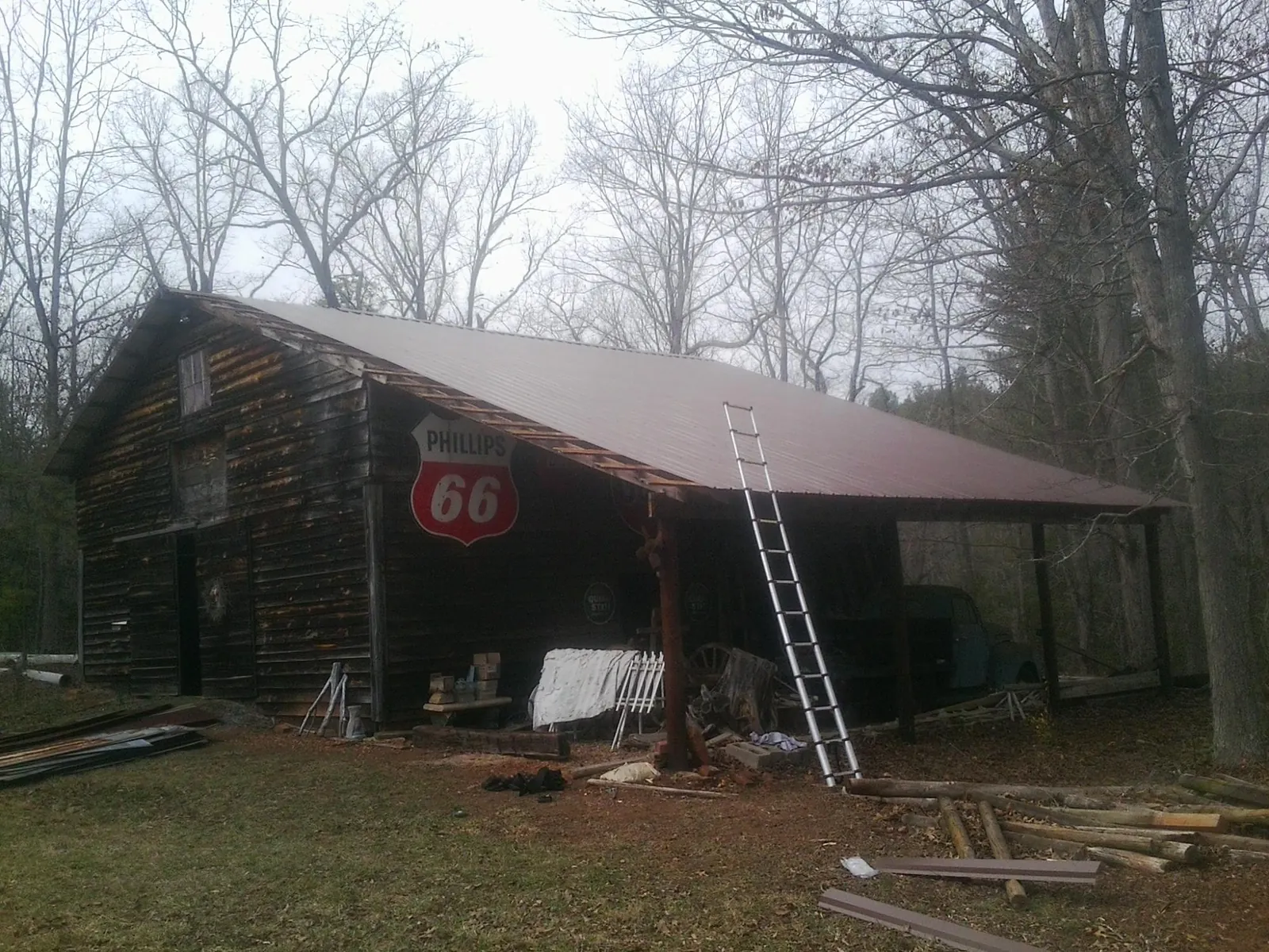 New metal roof on an open sided timber barn with a vintage sign in Eagan