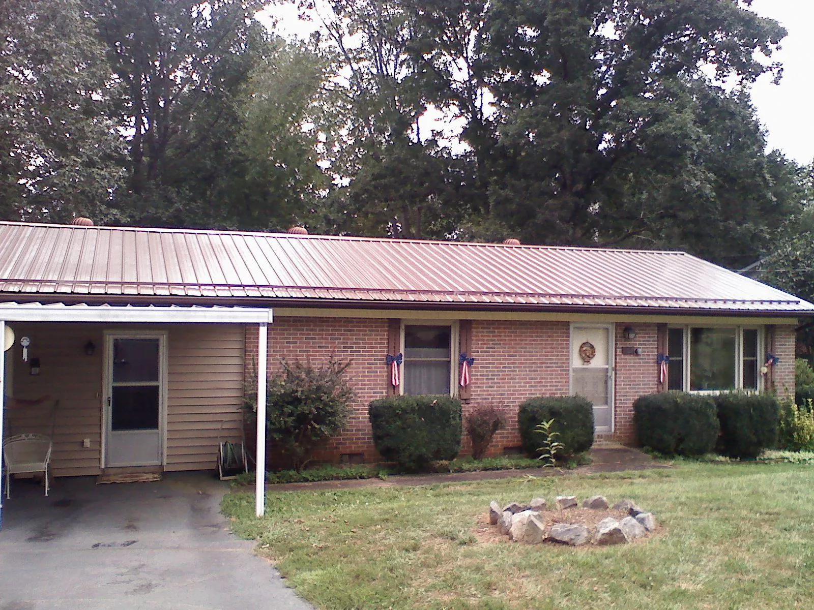 Bronze metal roof and carport on a brick ranch home — Roof Repair work by our crew in Eagan